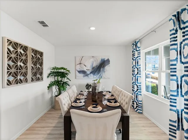 a table with a vase and flowers on it