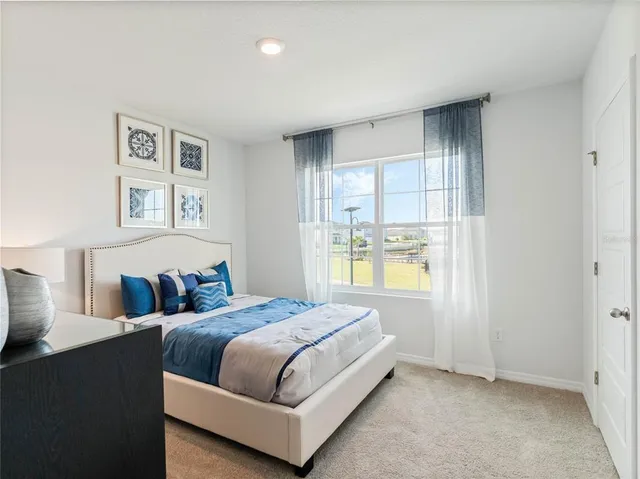 a bedroom with a large bed and a window