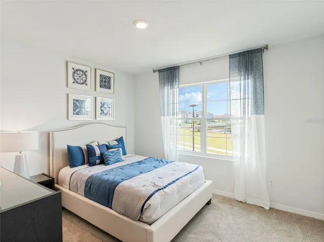 a bedroom with a large bed and a window