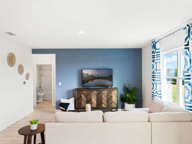 a living room with furniture and a large window