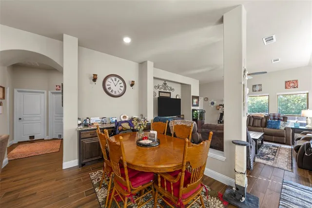 a view of a dining room with furniture and wooden floor