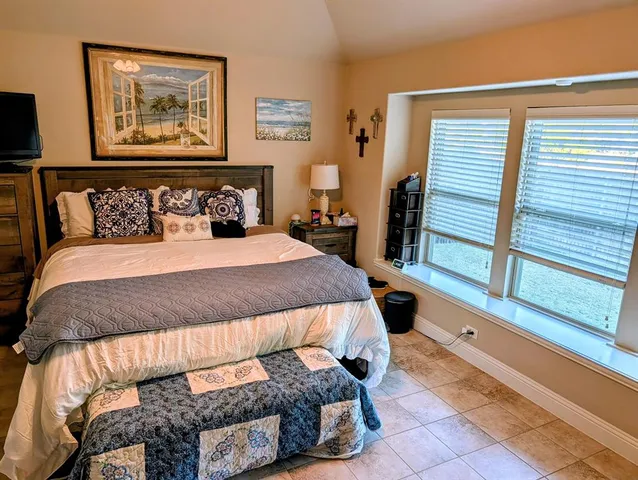 a bedroom with a bed and a window