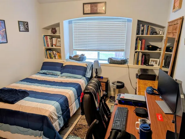 a bedroom with a bed and a book shelf