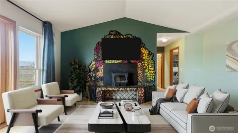 a living room with furniture fireplace and a large window