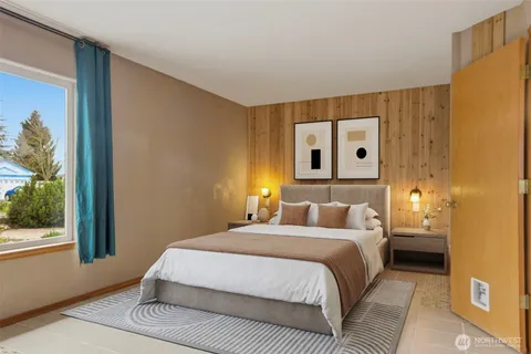 a bedroom with a large bed and a window