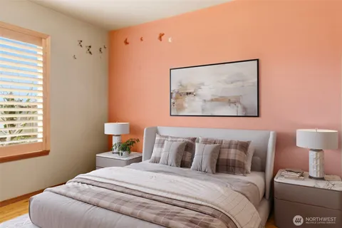 a bedroom with a bed and a lamp on dresser