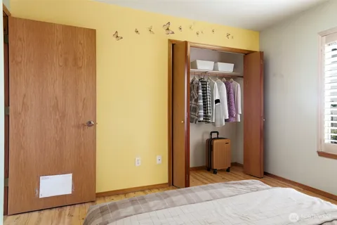 a view of a hallway with closet and front door