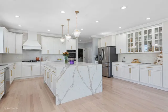 a large kitchen with kitchen island a sink a center island stainless steel appliances and a cabinets
