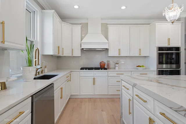 a kitchen with cabinets appliances a sink and a counter top space