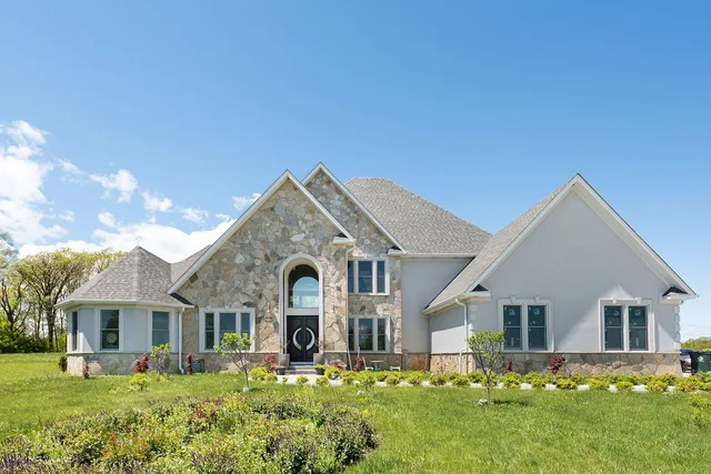 a front view of house with yard and green space
