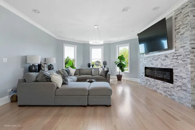 a living room with furniture a flat screen tv and a fireplace