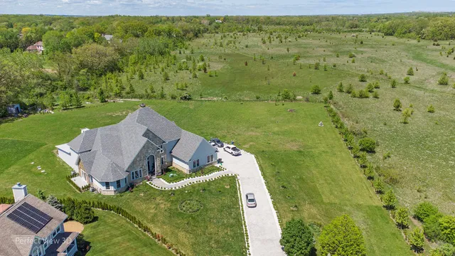 a view of backyard with swimming pool and green space