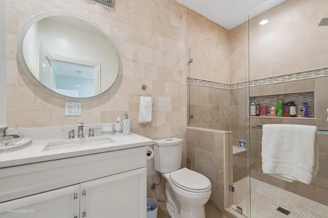 a bathroom with a sink vanity tub and shower