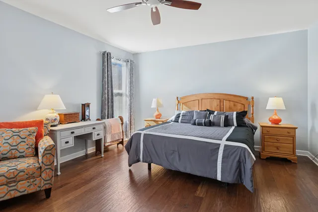 a bedroom with furniture and a wooden floor