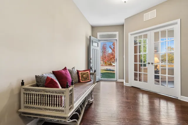a balcony with furniture and wooden floor