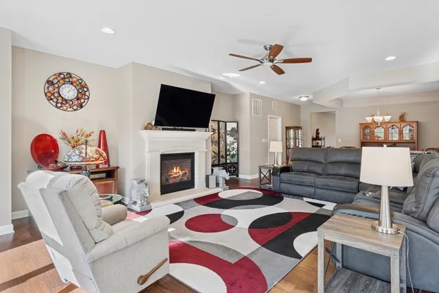 a living room with furniture fireplace and flat screen tv