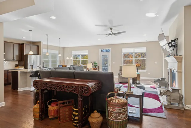 a living room with furniture a fireplace and flat screen tv