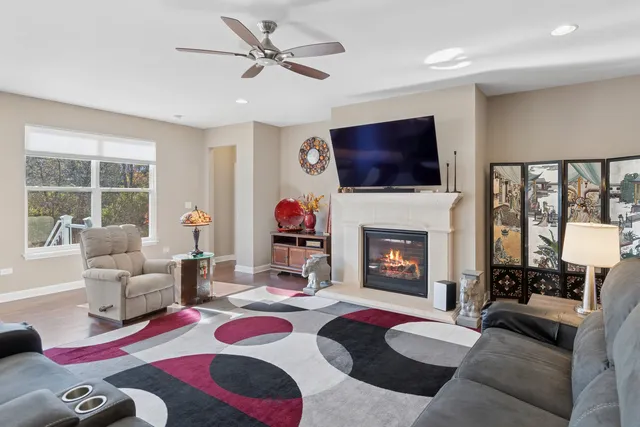 a living room with furniture a flat screen tv and a fireplace