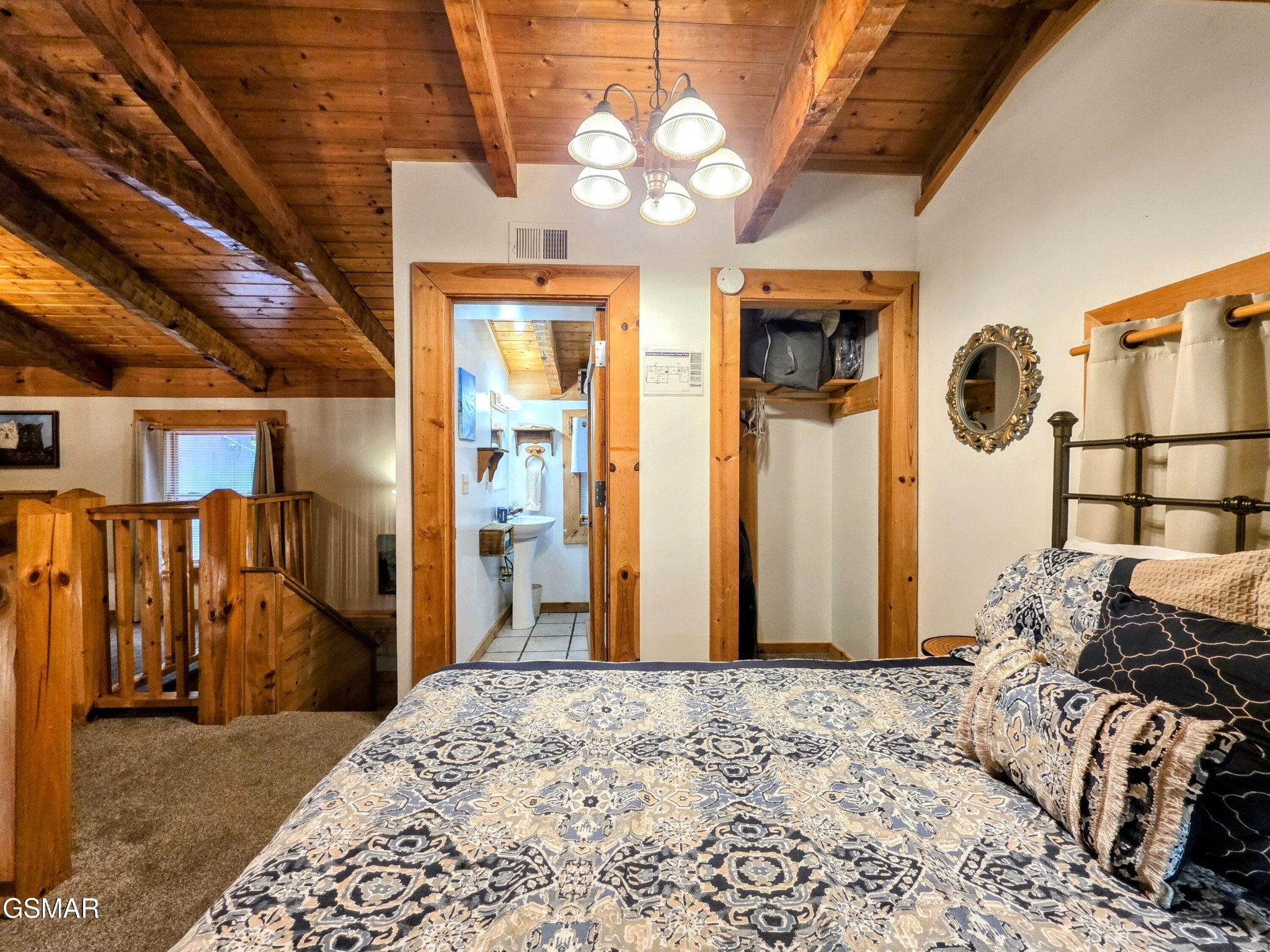 2570 Pittman Center Road Sevierville, TN 37876 - Photo 27 of 61 a bedroom with a bed and a chandelier