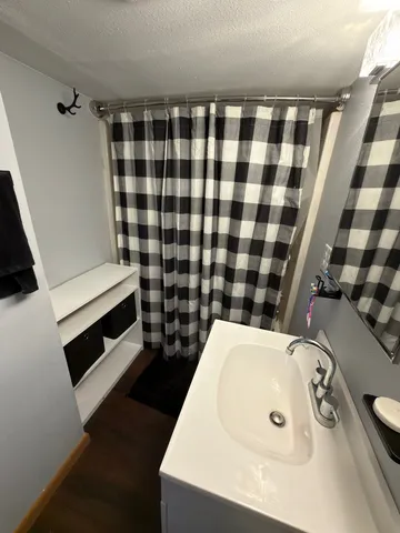 a bathroom with a toilet sink and mirror
