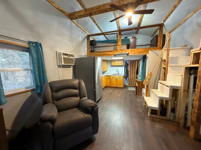 a living room with a fireplace furniture and a flat screen tv