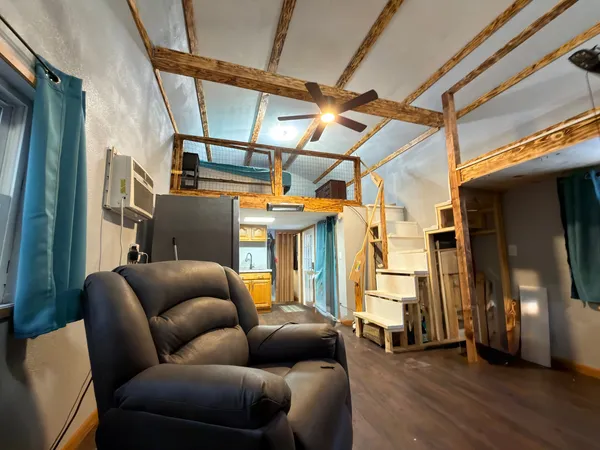 a backyard of a house with barbeque oven table and chairs