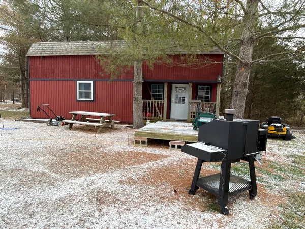 a backyard of a house with parking area