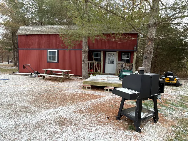 a backyard of a house with parking area