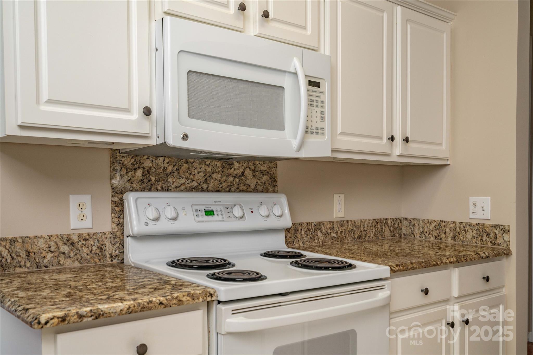 9514 Kestral Ridge Drive Charlotte, NC 28269 - Photo 13 of 32 a kitchen with granite countertop stove top oven and cabinets