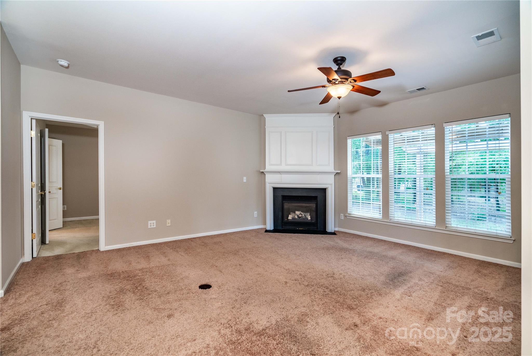 9514 Kestral Ridge Drive Charlotte, NC 28269 - Photo 17 of 32 an empty room with windows and fireplace