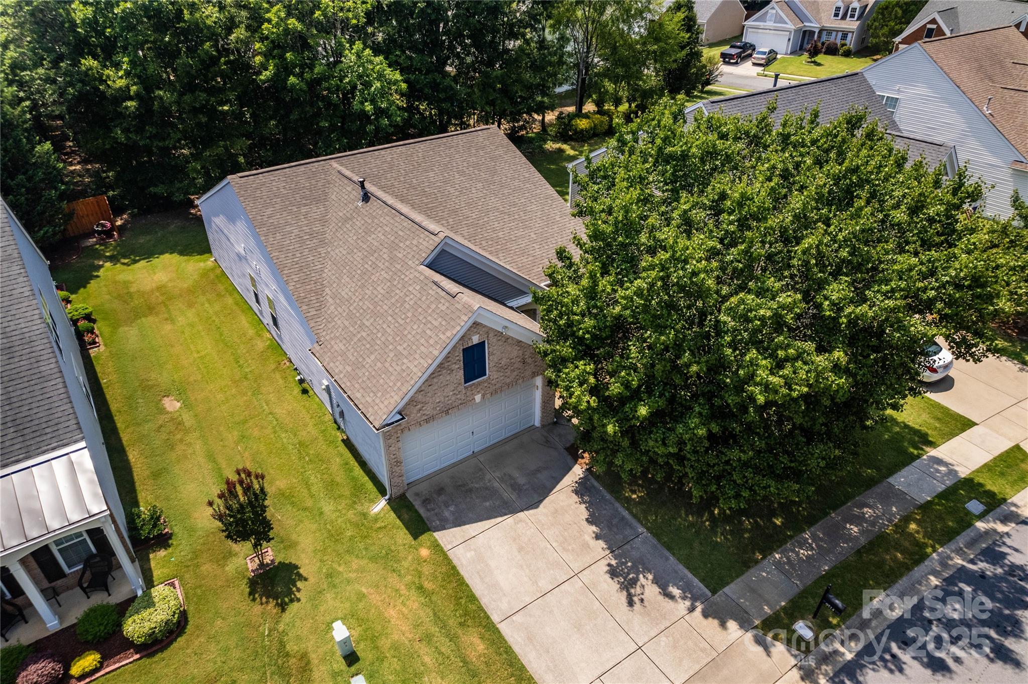 9514 Kestral Ridge Drive Charlotte, NC 28269 - Photo 2 of 32 an aerial view of a house with swimming pool and large trees