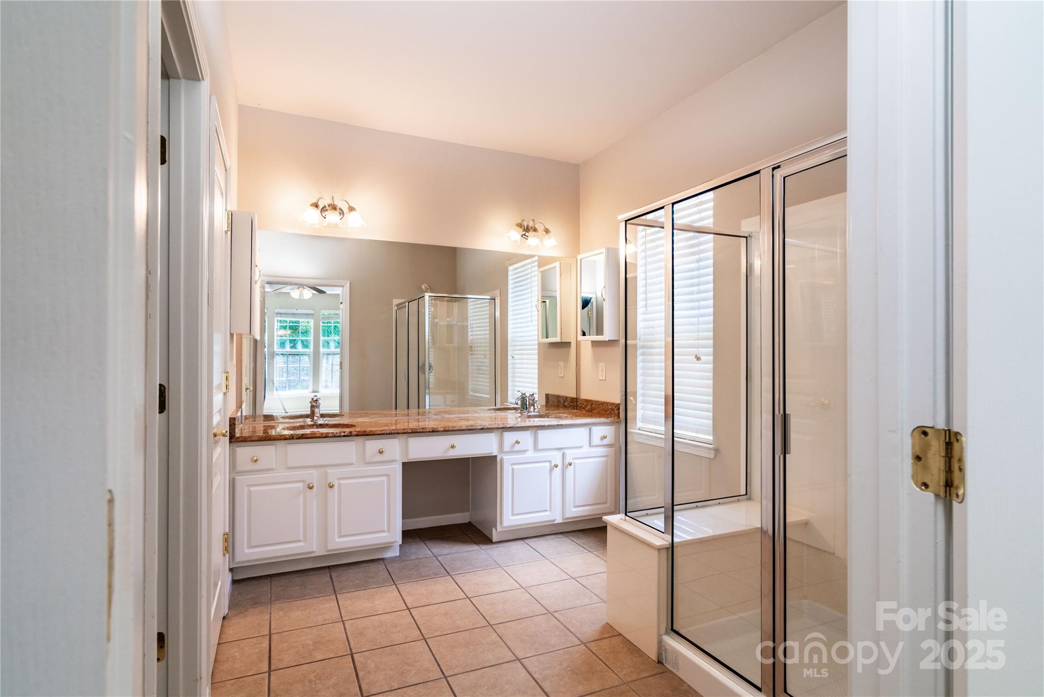 9514 Kestral Ridge Drive Charlotte, NC 28269 - Photo 22 of 32 a bathroom with a shower sink and mirror