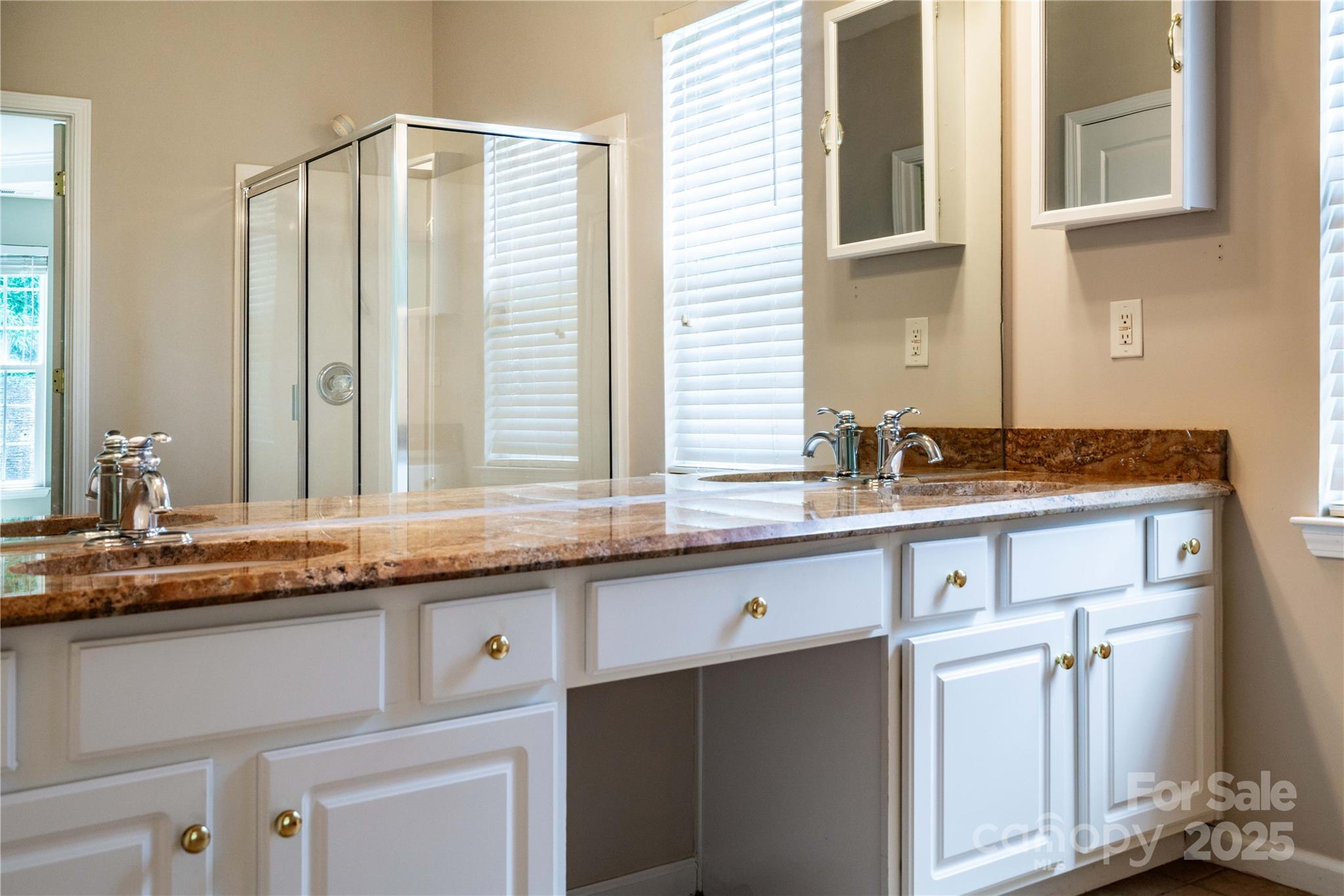 9514 Kestral Ridge Drive Charlotte, NC 28269 - Photo 25 of 32 a kitchen with granite countertop a sink and a white cabinets