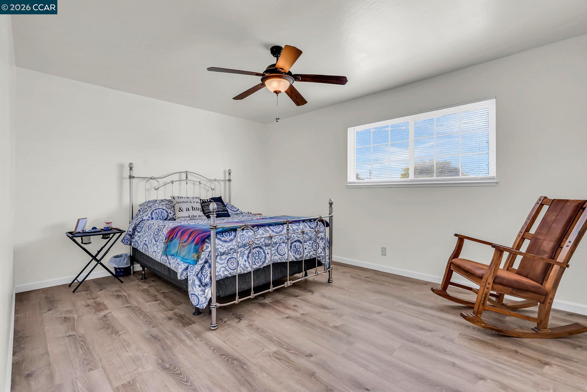 183 West Leland Road Pittsburg, CA 94565 - Photo 11 of 21 a bedroom with a bed and wooden floor