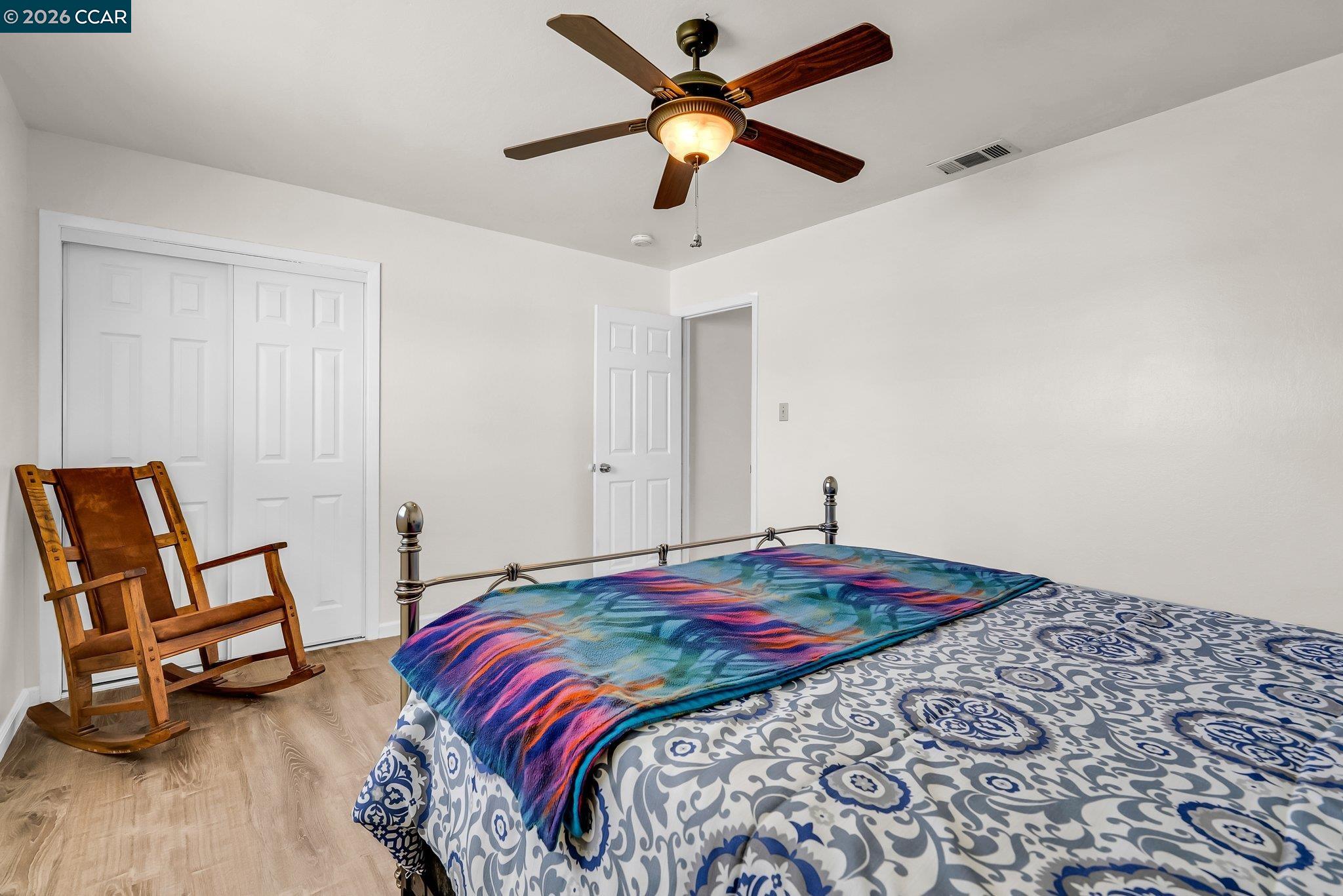 183 West Leland Road Pittsburg, CA 94565 - Photo 13 of 21 a bedroom with a bed and a chair