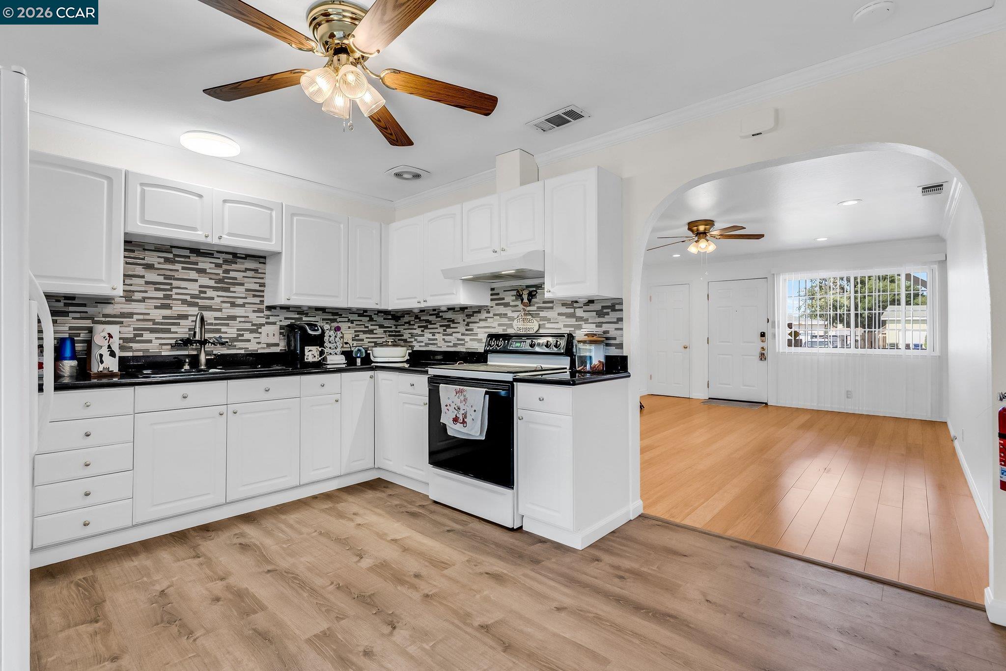183 West Leland Road Pittsburg, CA 94565 - Photo 6 of 21 a kitchen with stainless steel appliances granite countertop a stove a sink and a refrigerator