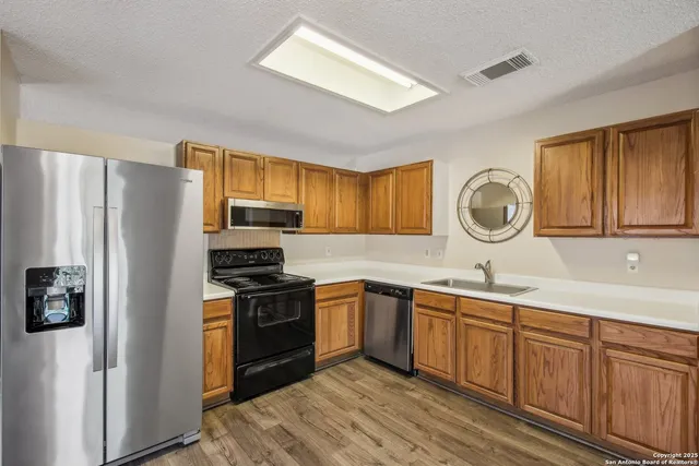 a kitchen with a sink stove and refrigerator