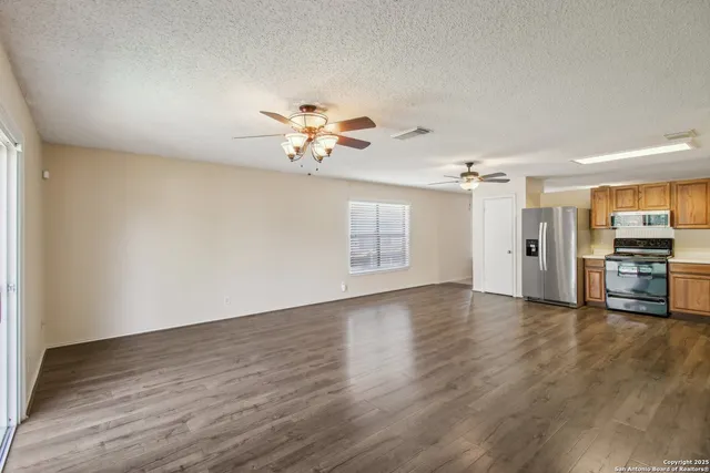 a view of an empty room with a chandelier