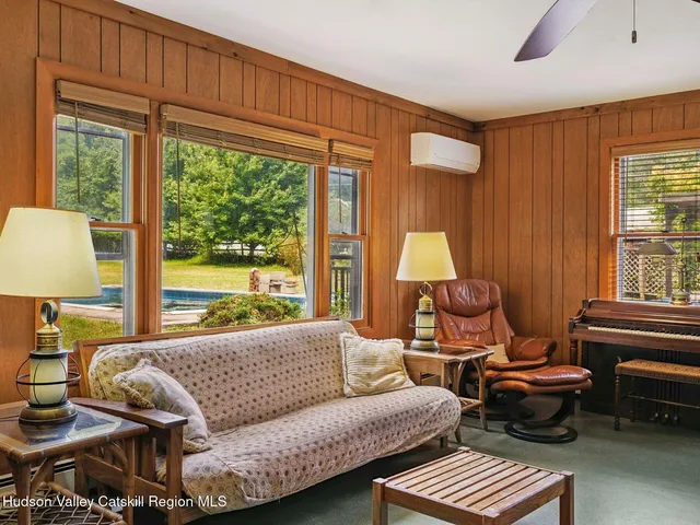 a view of a swimming pool with lawn chairs under an umbrella