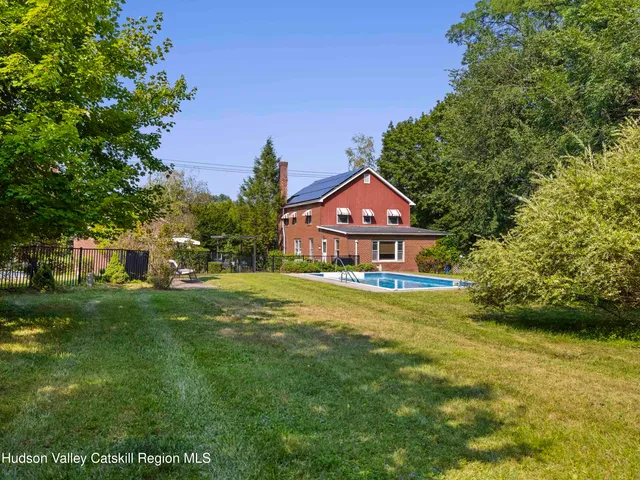 a front view of house with yard and outdoor seating