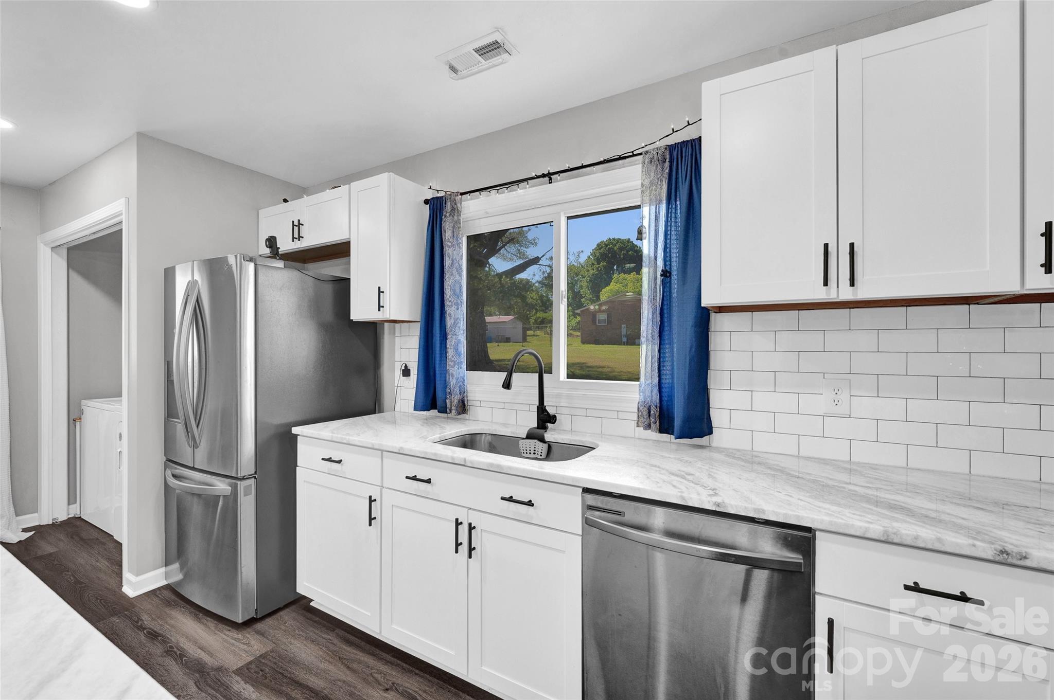 3033 West Highway 10 Conover, NC 28613 - Photo 15 of 26 a kitchen with stainless steel appliances granite countertop a refrigerator and a sink