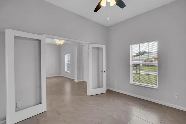 an empty room with windows and closet