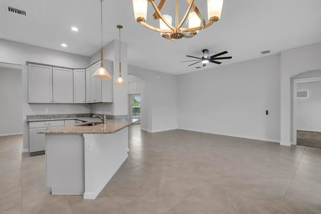 a view of a kitchen with a sink and a stove top oven