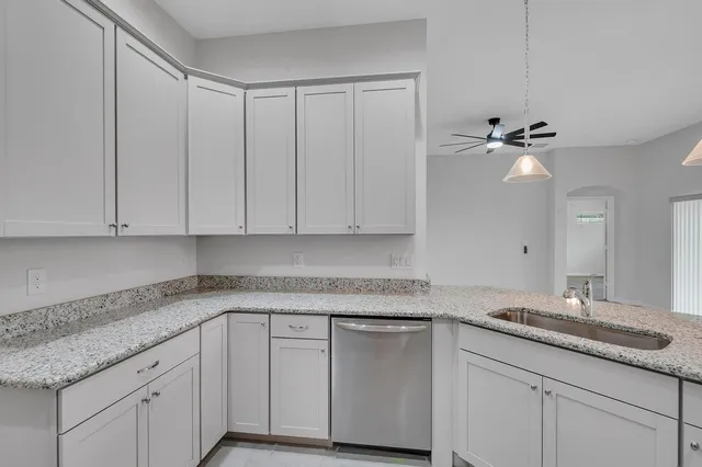 a kitchen with granite countertop cabinets and sink