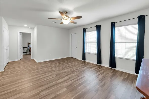 a view of kitchen with granite countertop cabinets and refrigerator