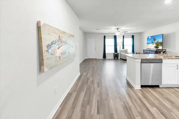 a kitchen with stainless steel appliances granite countertop a stove a sink dishwasher and a microwave oven with wooden cabinets