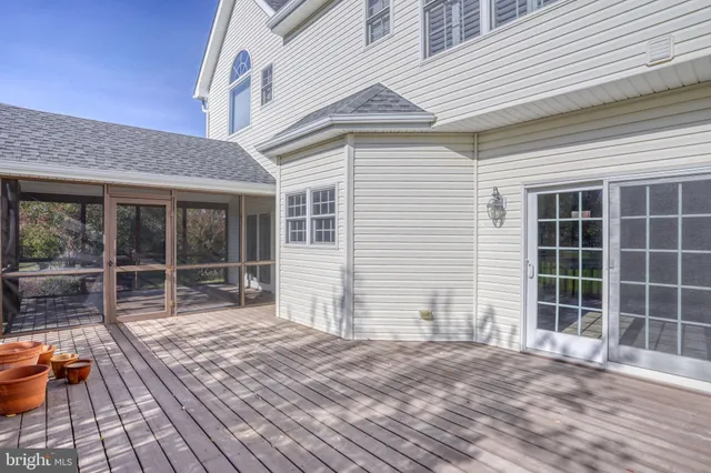 a view of a house with a wooden deck