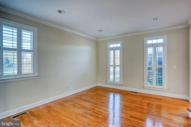 a view of a hallway with a dining table and chairs