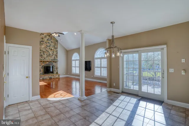 an empty room with a ceiling fan and carpet