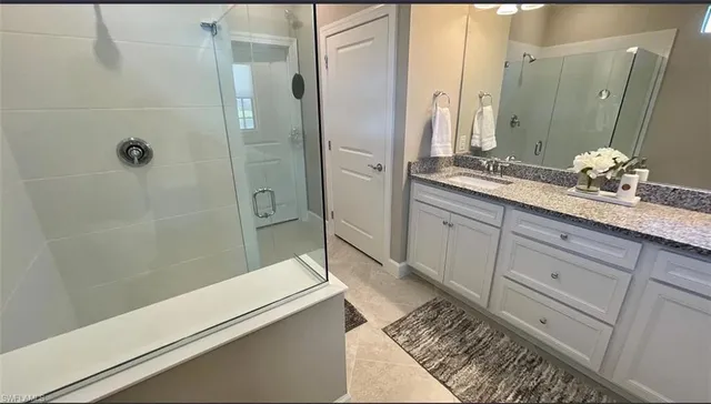 a bathroom with a double vanity sink a toilet and a mirror